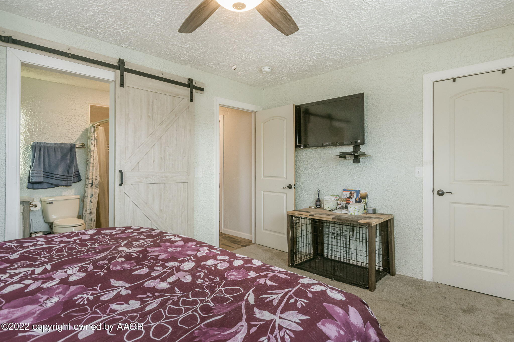 4801 Gary Lane Amarillo, TX 79110 - Photo 10 of 21 a bedroom with a bed and a chandelier