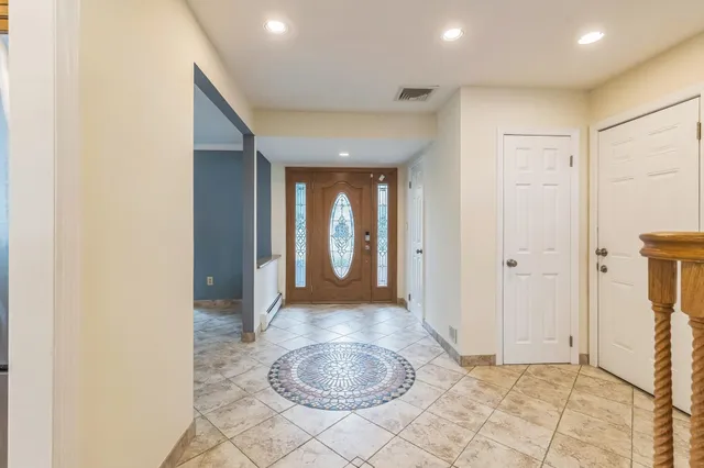 a view of a hallway with bathroom and a sink