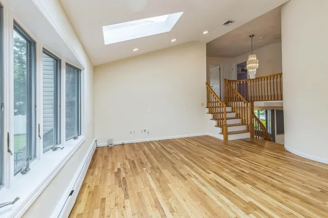 a view of a room with wooden floor and stairs