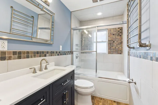 a bathroom with a sink toilet and shower