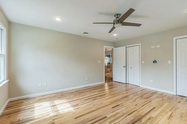 a view of an empty room and wooden floor