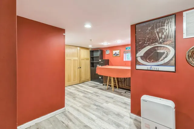 a bedroom with a bed and a chair in it