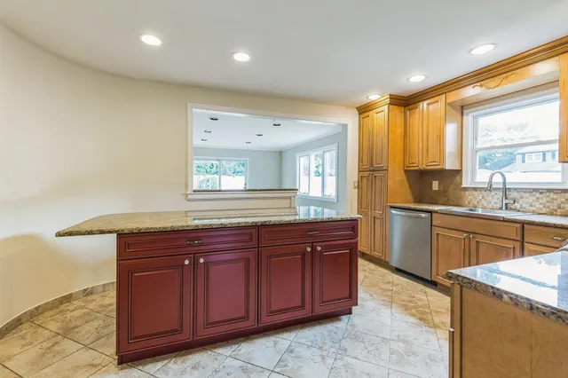 a spacious bathroom with a granite countertop sink and a large mirror