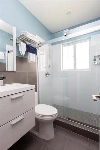 a bathroom with a toilet a sink and shower