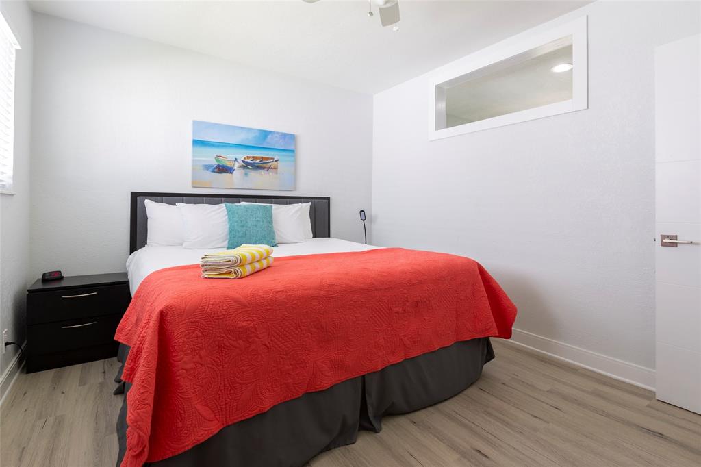 3217 Northeast 9th Street, Unit 5 Pompano Beach, FL 33062 - Photo 3 of 12 a bed sitting in a bedroom next to a wall