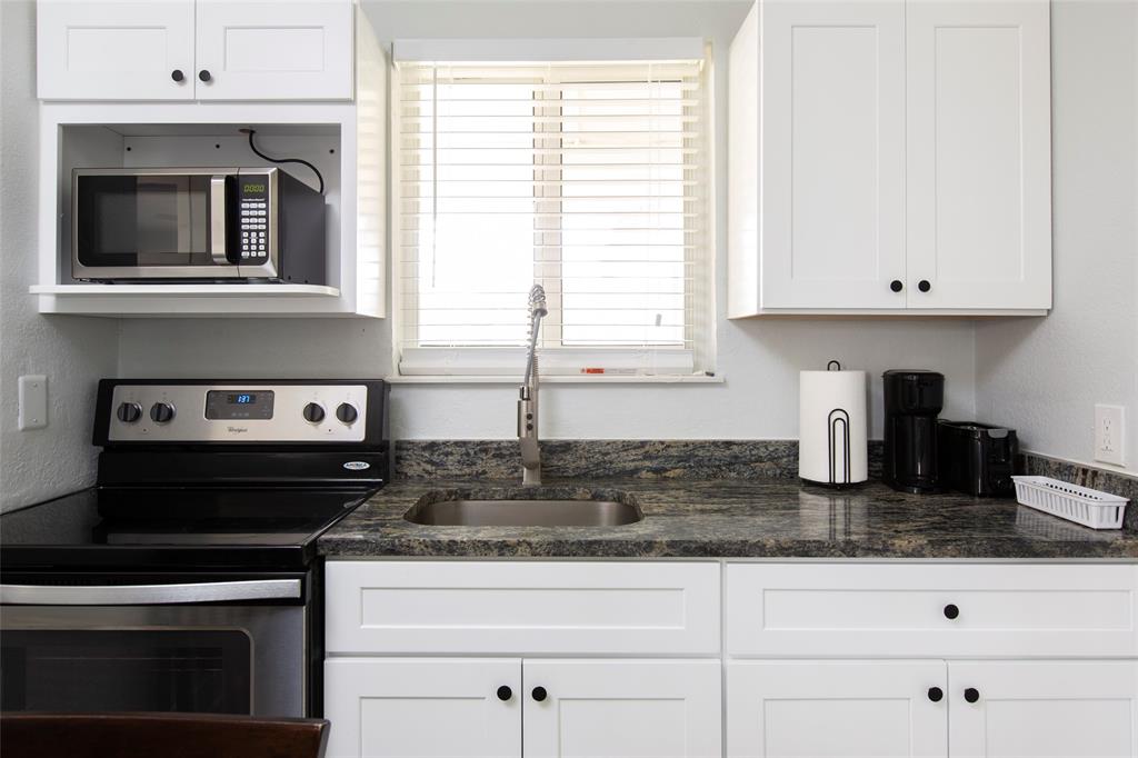 3217 Northeast 9th Street, Unit 5 Pompano Beach, FL 33062 - Photo 5 of 12 a kitchen with granite countertop a stove a sink and a granite counter tops