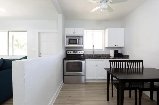 a kitchen with a stove a sink and a microwave