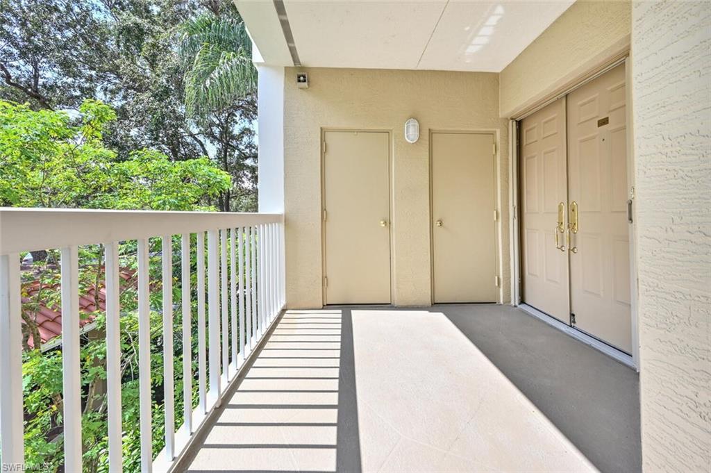 6549 Marissa Loop, Unit 26 Naples, FL 34108 - Photo 2 of 39 a view of a porch with wooden floor