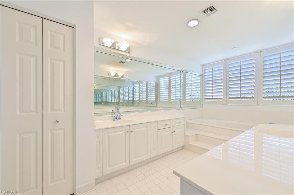 6549 Marissa Loop, Unit 26 Naples, FL 34108 - Photo 23 of 39 a large white bathroom with a large tub sink and vanity