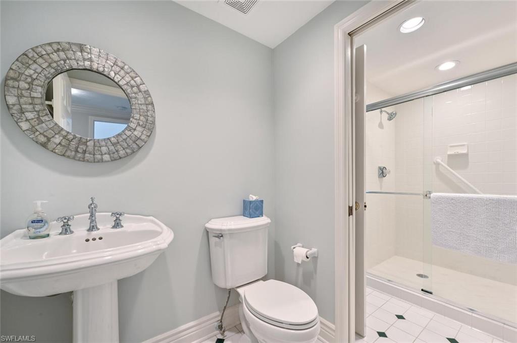 6549 Marissa Loop, Unit 26 Naples, FL 34108 - Photo 27 of 39 a bathroom with a toilet sink shower and mirror