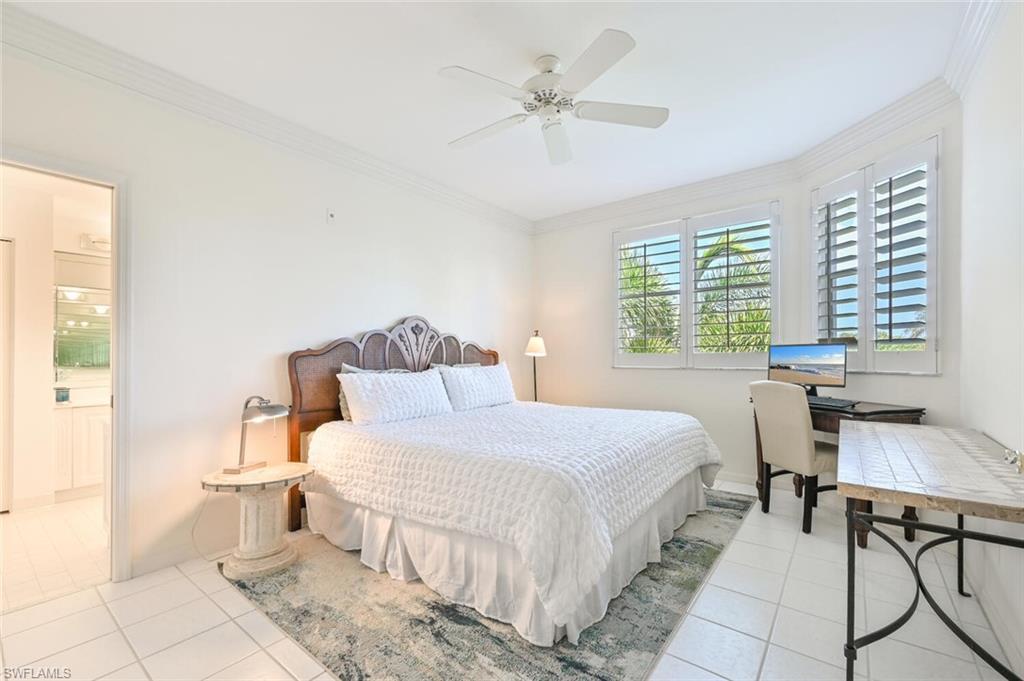 6549 Marissa Loop, Unit 26 Naples, FL 34108 - Photo 28 of 39 a bedroom with a bed and a table in it with window