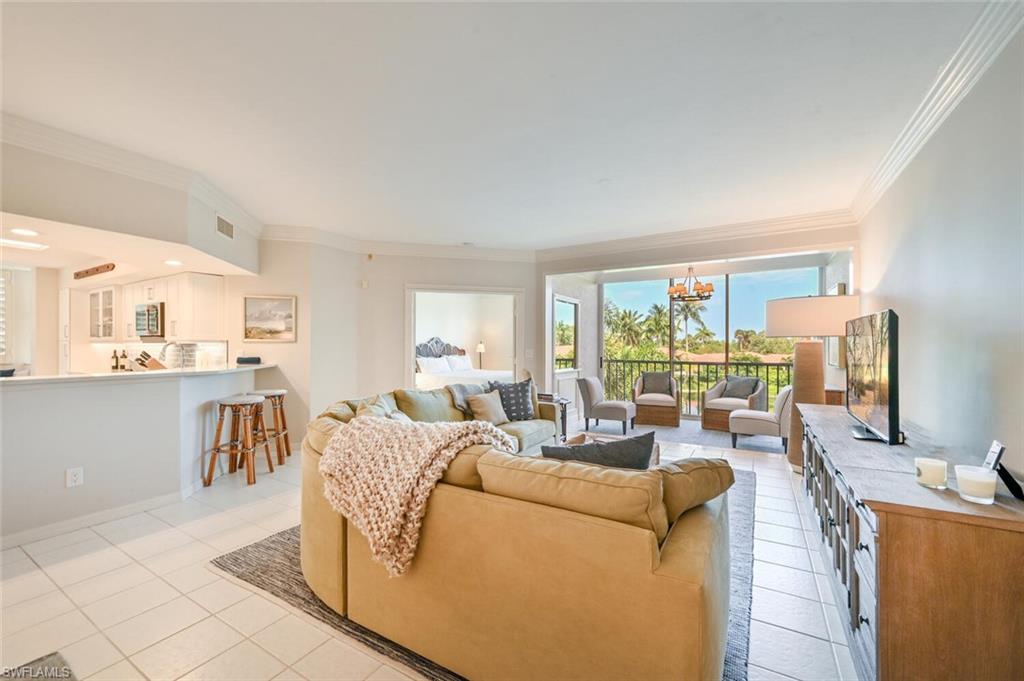 6549 Marissa Loop, Unit 26 Naples, FL 34108 - Photo 5 of 39 a living room with fireplace furniture and a large window