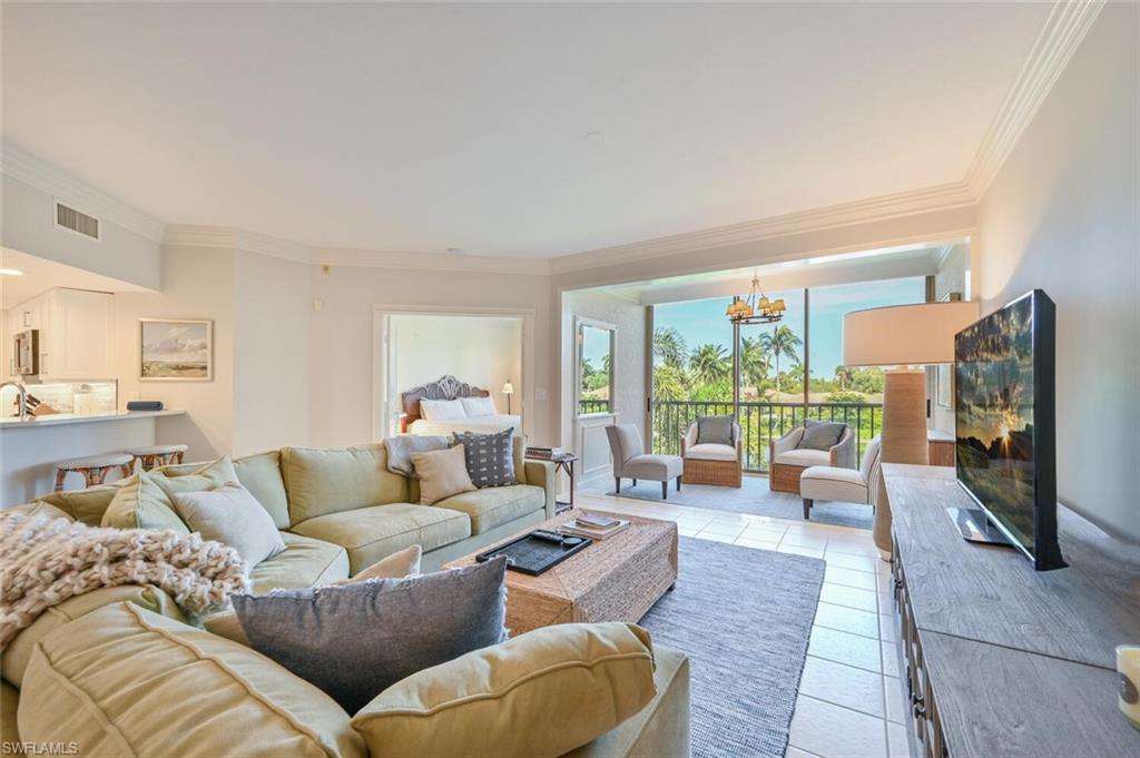 6549 Marissa Loop, Unit 26 Naples, FL 34108 - Photo 8 of 39 a living room with furniture and a flat screen tv