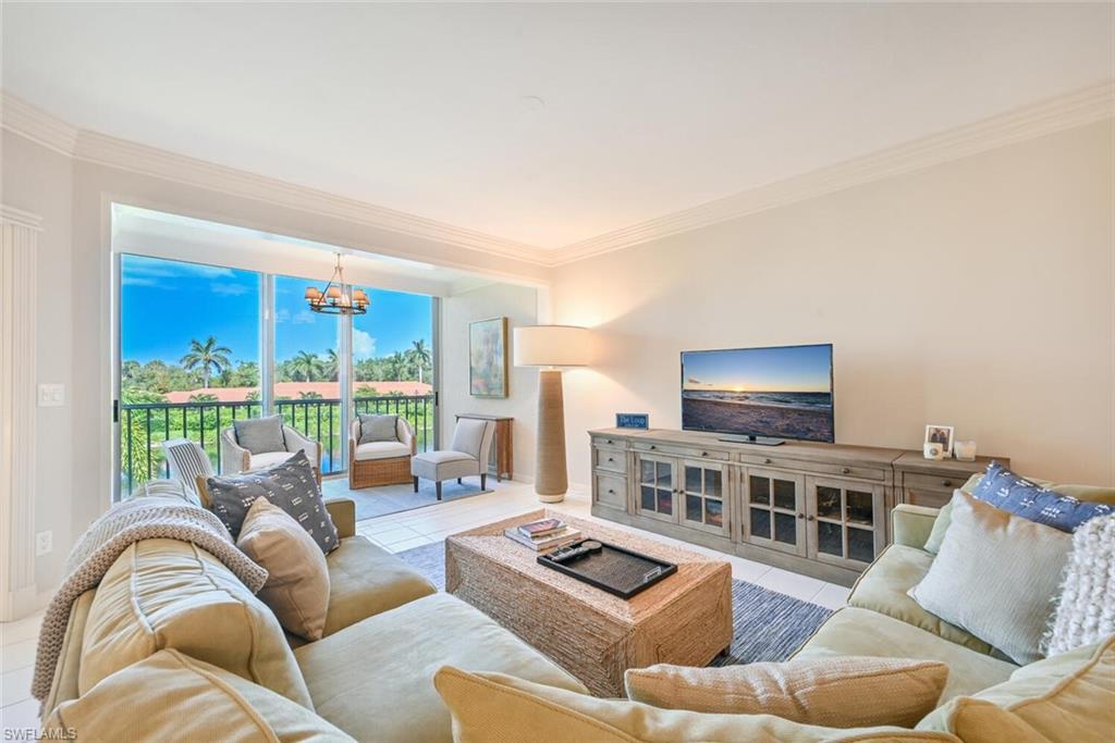 6549 Marissa Loop, Unit 26 Naples, FL 34108 - Photo 9 of 39 a living room with furniture and a flat screen tv