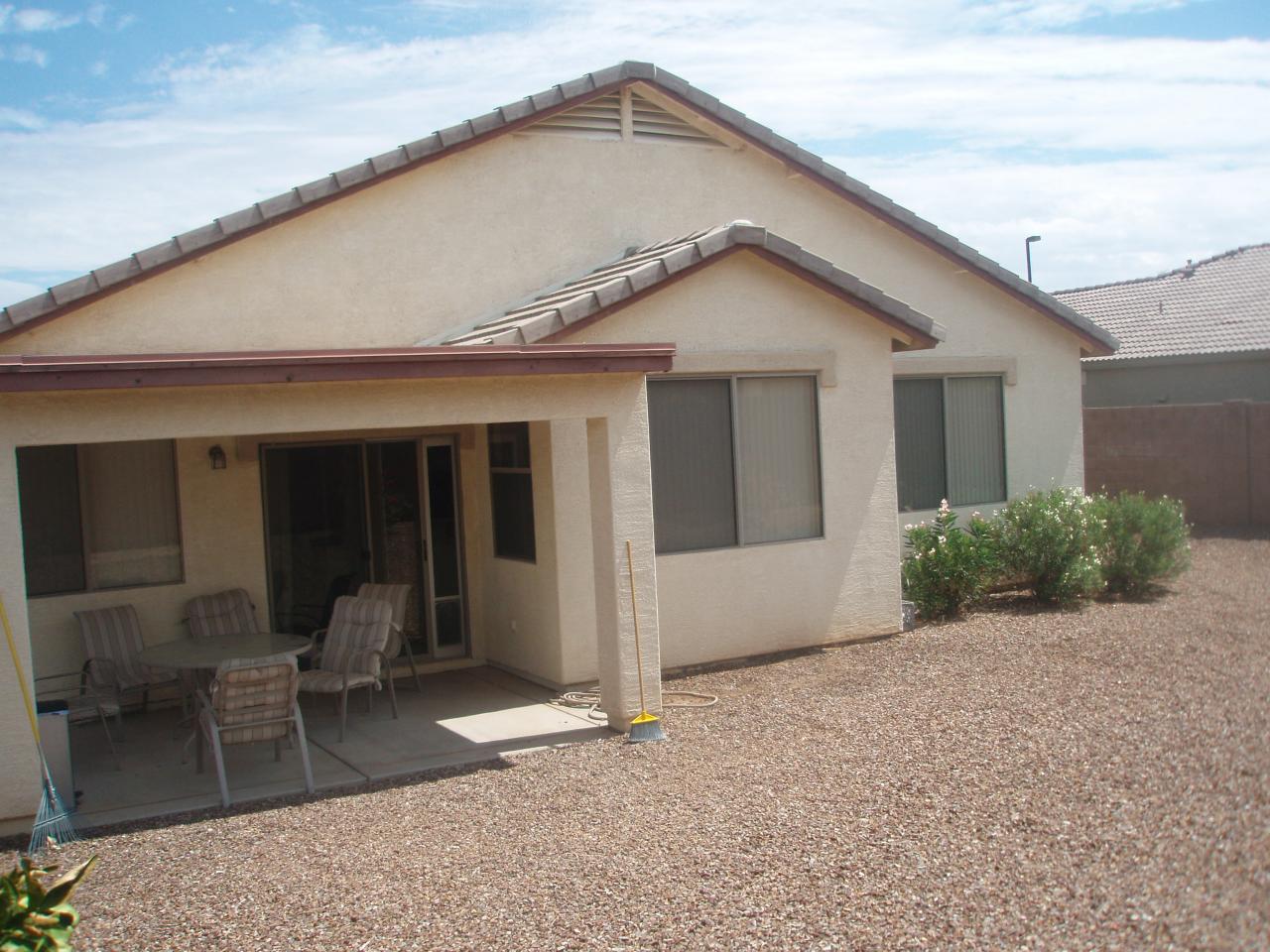 4230 South Splendor Place Gilbert, AZ 85297 - Photo 6 of 11 a backyard of a house with outdoor seating and barbeque oven