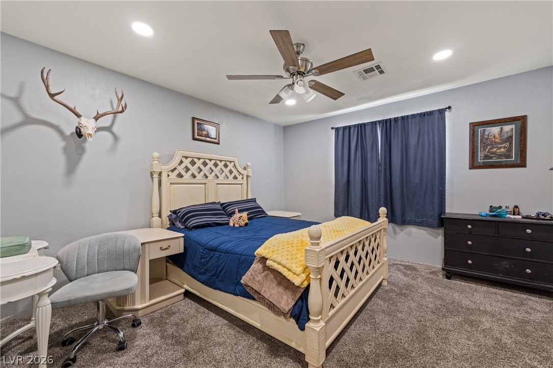 750 Leming Avenue Overton, NV 89040 - Photo 51 of 82 This cozy bedroom features plush carpeting and a cooling ceiling fan, perfect for restful nights.