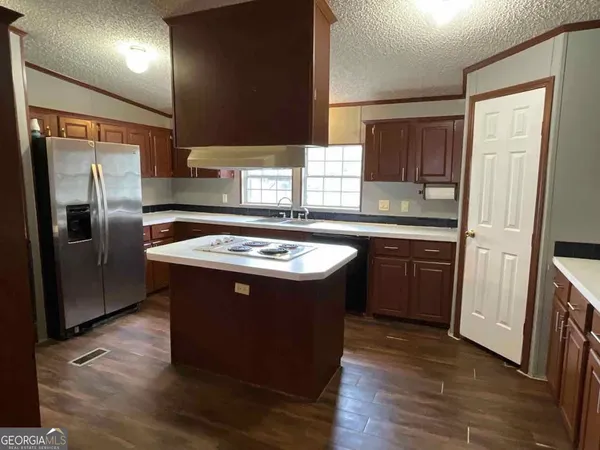 a kitchen with a sink and a refrigerator