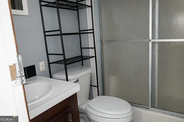 a white toilet sitting next to a bathroom sink