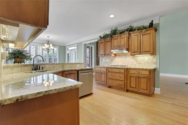 a view of a livingroom with wooden floor and a fireplace