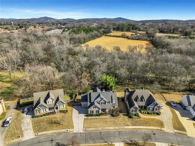 a living room with furniture a fireplace and a large window