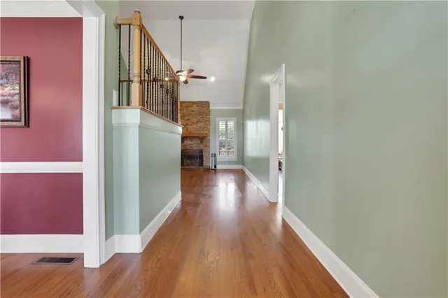 a view of a livingroom with wooden floor and stairs