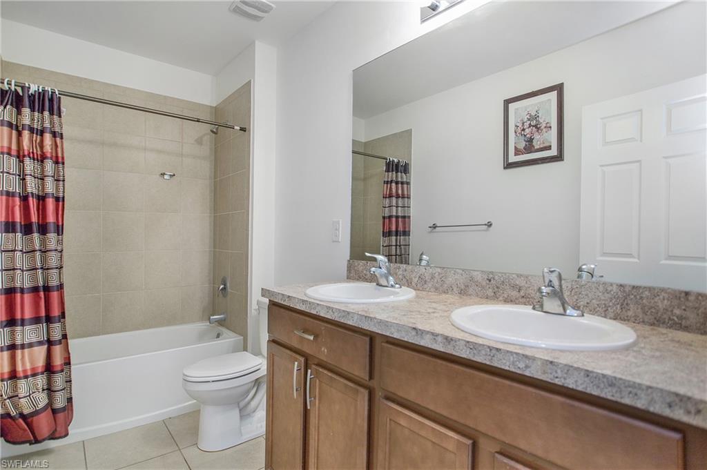 673 Hadley Street East Naples, FL 34104 - Photo 22 of 31 a bathroom with a granite countertop sink toilet and shower