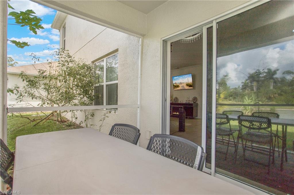 673 Hadley Street East Naples, FL 34104 - Photo 26 of 31 a bedroom with a bed and a painting on the wall