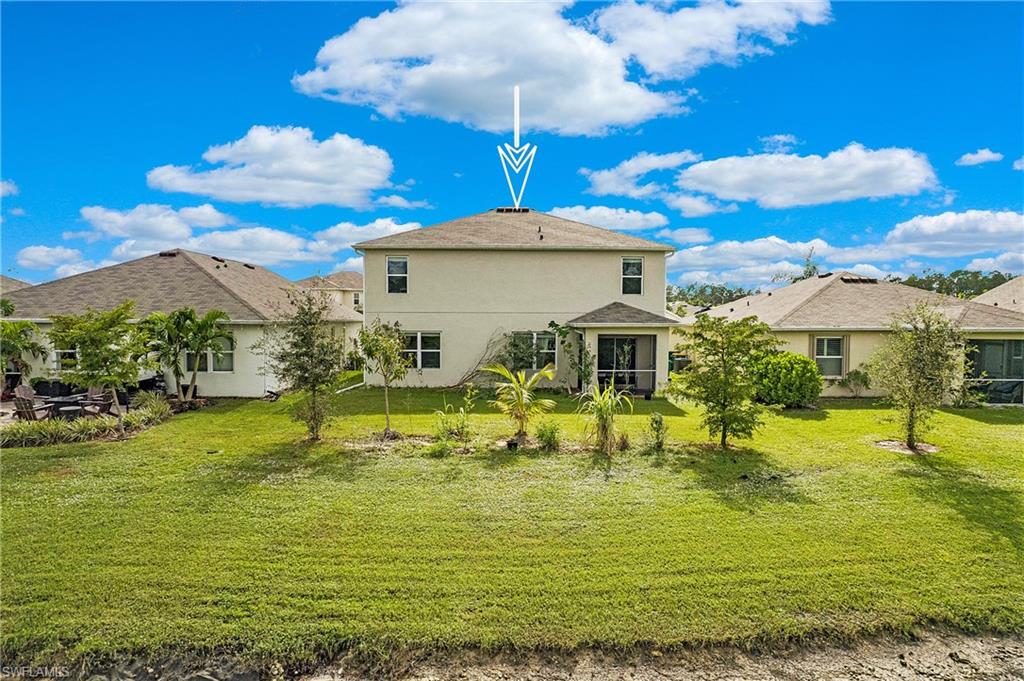 673 Hadley Street East Naples, FL 34104 - Photo 29 of 31 a view of a swimming pool with a table and chairs