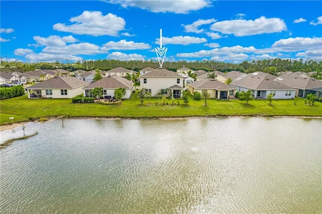 a view of house with outdoor space and lake view