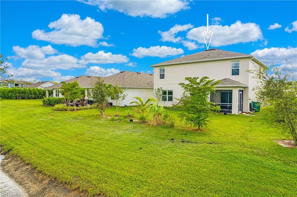 673 Hadley Street East Naples, FL 34104 - Photo 4 of 31 a front view of a house with garden