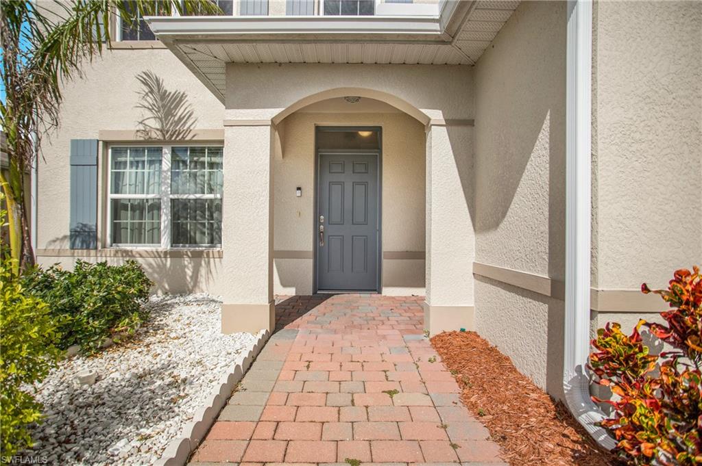 673 Hadley Street East Naples, FL 34104 - Photo 5 of 31 a front view of a house with garden