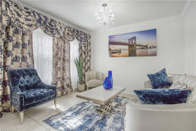 a living room with furniture and a chandelier