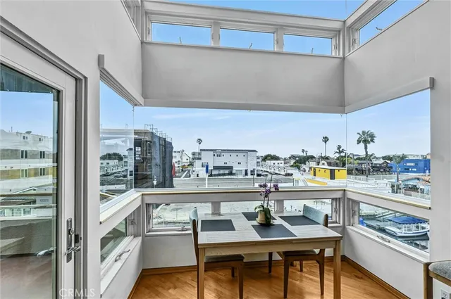 a room with stainless steel appliances kitchen island granite countertop a table and chairs in it