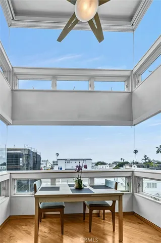 a view of kitchen with stainless steel appliances wooden floor and cabinets