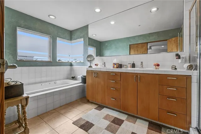 a bathroom with a tub sink toilet and mirror