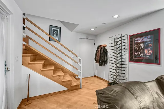 a bedroom with furniture a flat screen tv and a window