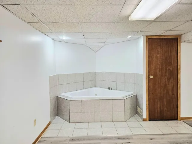 a bathroom with a bathtub and shower