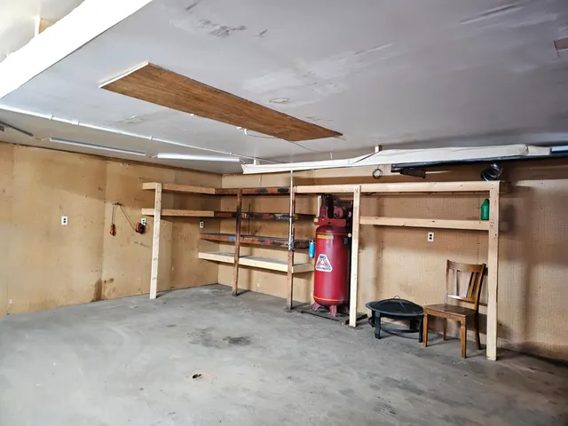 a view of a room with wooden shelves