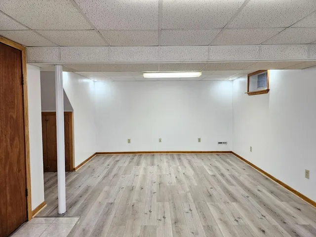 a view of a room with wooden floor