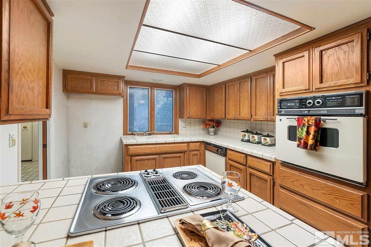 2107 Chicory Way Reno, NV 89509 - Photo 3 of 24 a kitchen with a stove and a white refrigerator