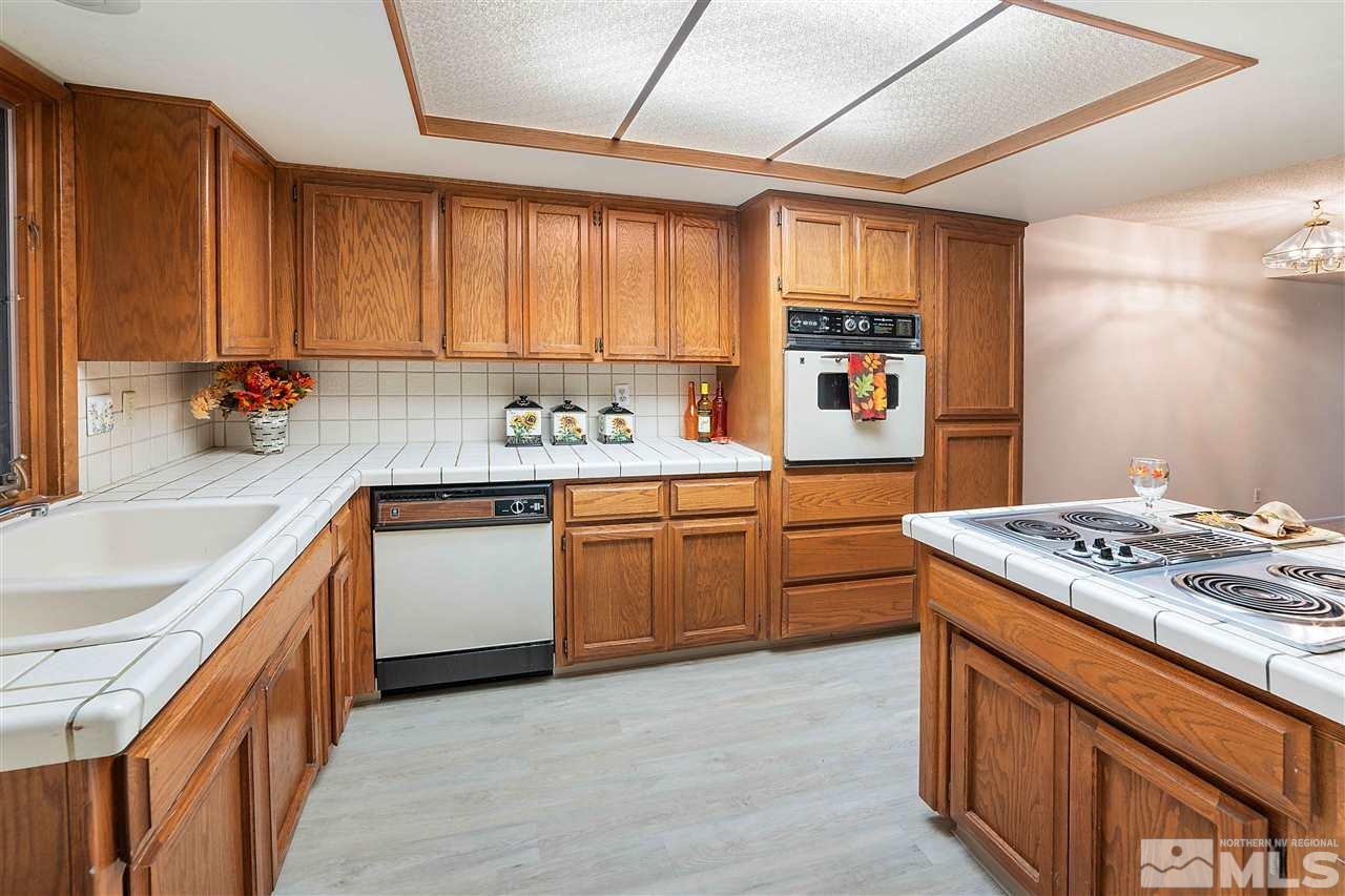 2107 Chicory Way Reno, NV 89509 - Photo 4 of 24 a kitchen with a stove sink and cabinets