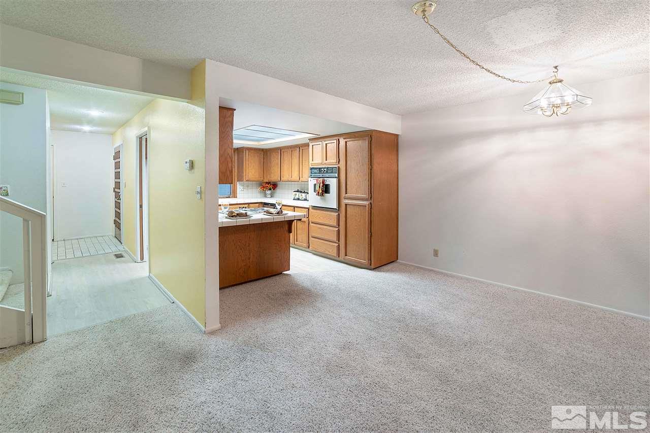 2107 Chicory Way Reno, NV 89509 - Photo 5 of 24 a kitchen with stainless steel appliances granite countertop a refrigerator and a stove top oven