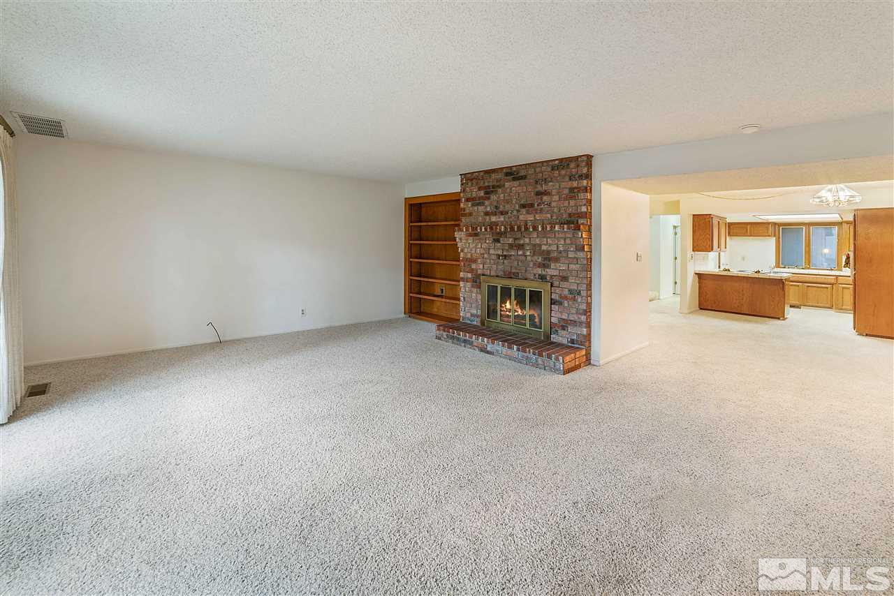 2107 Chicory Way Reno, NV 89509 - Photo 7 of 24 a view of an empty room with a fireplace and a window