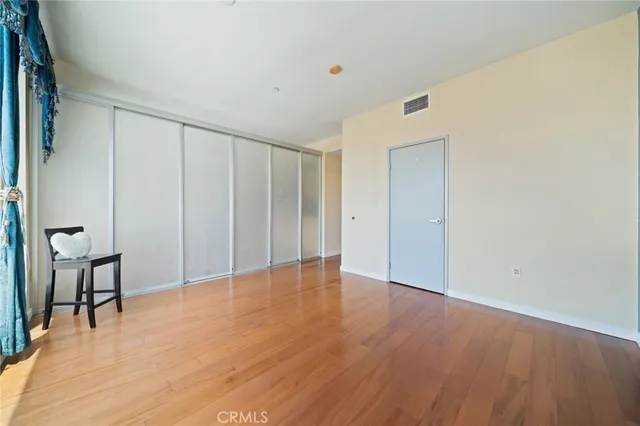 a bathroom with a granite countertop toilet sink and mirror