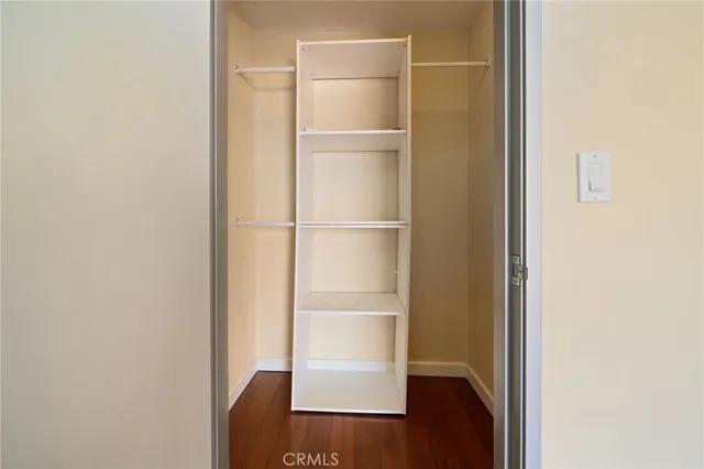 a view of walk in closet with empty racks