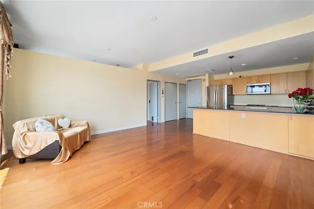 a kitchen with stainless steel appliances granite countertop a refrigerator a sink and a stove