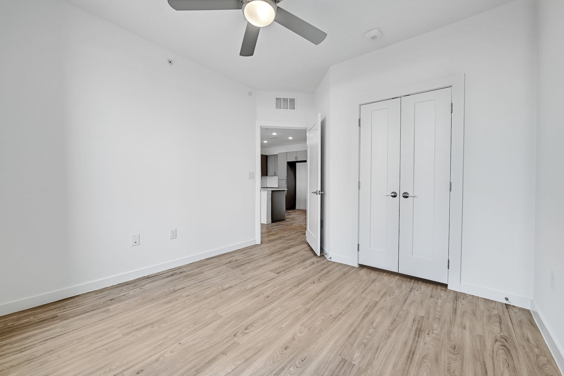4801 Springdale Road, Unit 1301 Austin, TX 78723 - Photo 15 of 39 A well-proportioned bedroom with rich wood-look flooring and a modern ceiling fan for comfort.