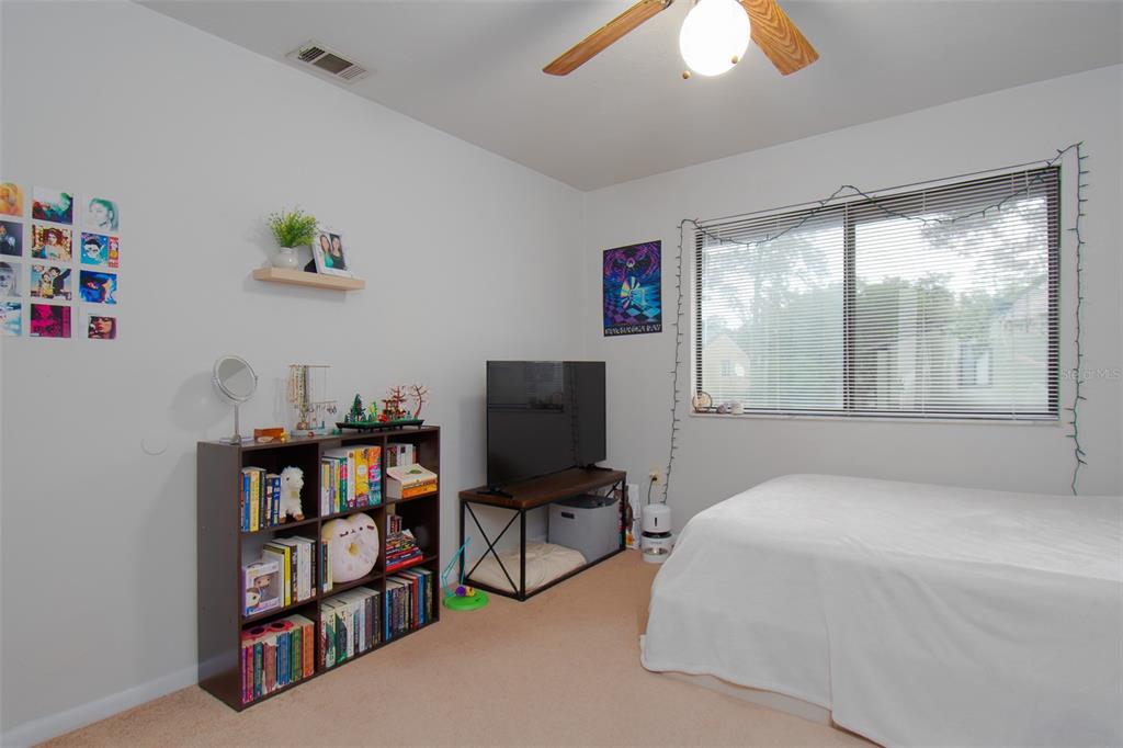 2300 Southwest 43rd Street, Unit K5 Gainesville, FL 32607 - Photo 3 of 18 a bedroom with a bed and a book shelf