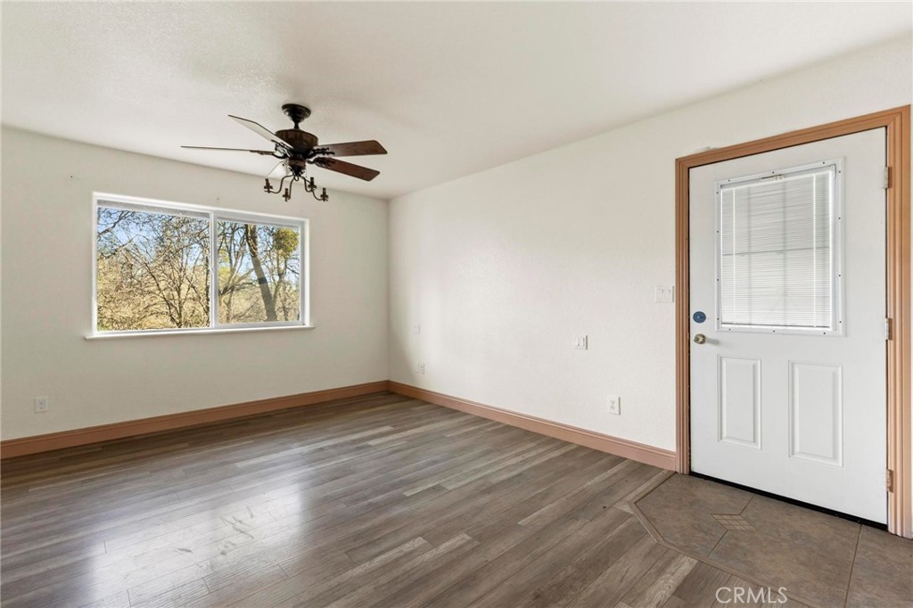 10761 Texas Hill Road Dobbins, CA 95935 - Photo 14 of 58 a view of an empty room with a window and wooden floor
