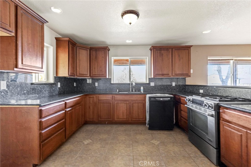 10761 Texas Hill Road Dobbins, CA 95935 - Photo 17 of 58 a kitchen with stainless steel appliances granite countertop a stove sink and cabinets